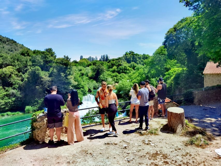 From Split & Trogir: Krka Waterfalls Day Tour with Boat Ride - Inside Krka: trails, renovated stone buildings, and the watermill stop