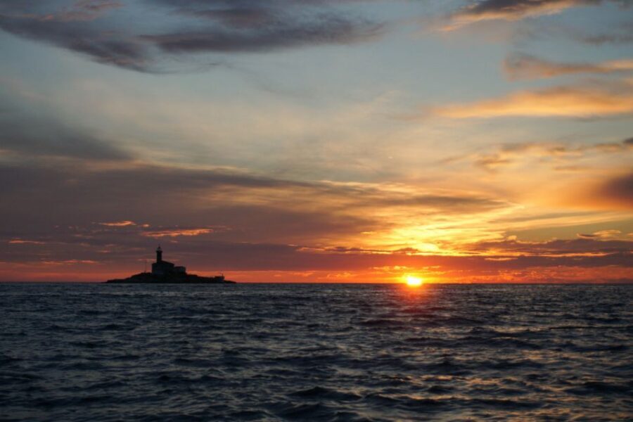 Rovinj: Sunset Boat Trip with Dolphin Watching - Sailing Out of Valdibora as the Coast Turns Pastel